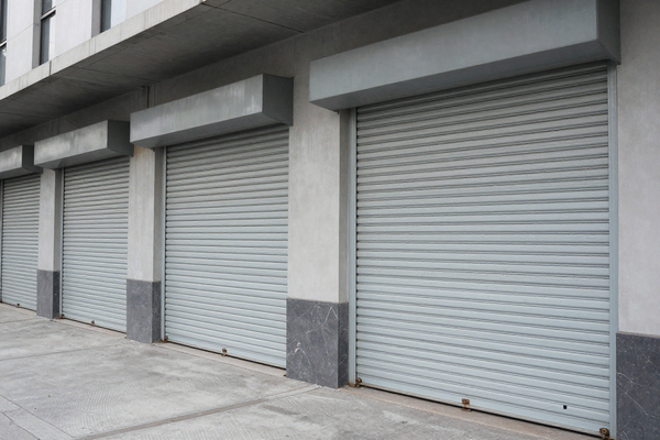 Metal roller shutters on commercial building, closed, urban setting